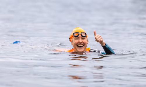 Swimmer gives thumbs up in water