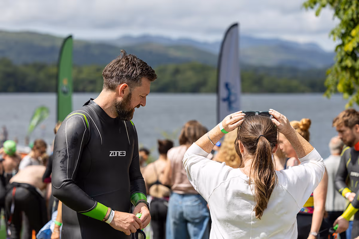 Man in Zone3 wetsuit preparing for a swim